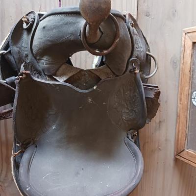 A SMALL CHILD'S SADDLE AND A STAINED GLASS STEER