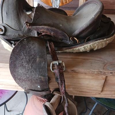 A SMALL CHILD'S SADDLE AND A STAINED GLASS STEER