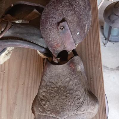 A SMALL CHILD'S SADDLE AND A STAINED GLASS STEER
