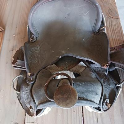 A SMALL CHILD'S SADDLE AND A STAINED GLASS STEER