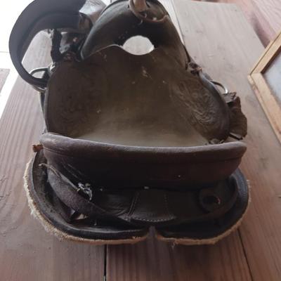 A SMALL CHILD'S SADDLE AND A STAINED GLASS STEER