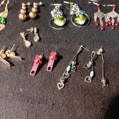 A COLLECTION OF PIERCED EARRINGS AND A COPPER BRACELET