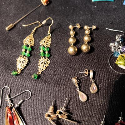 A COLLECTION OF PIERCED EARRINGS AND A COPPER BRACELET