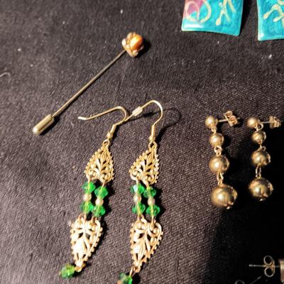 A COLLECTION OF PIERCED EARRINGS AND A COPPER BRACELET