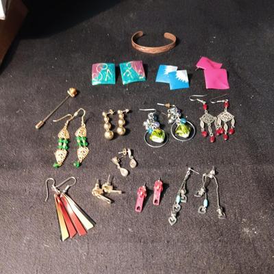 A COLLECTION OF PIERCED EARRINGS AND A COPPER BRACELET