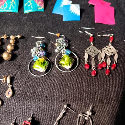 A COLLECTION OF PIERCED EARRINGS AND A COPPER BRACELET