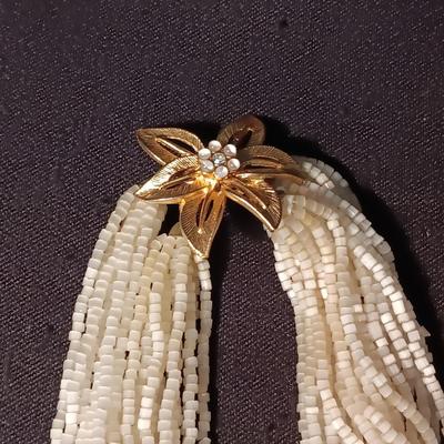 MULTI STRAND BEADED NECKLACE WITH GOLD TONE FLOWER CLASP