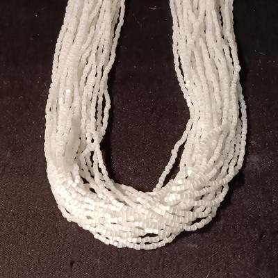 MULTI STRAND BEADED NECKLACE WITH GOLD TONE FLOWER CLASP