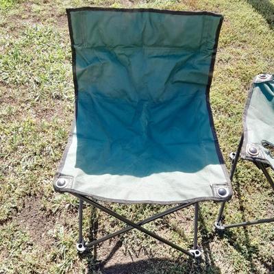 Two folding camp chairs and a folding table with drink holders