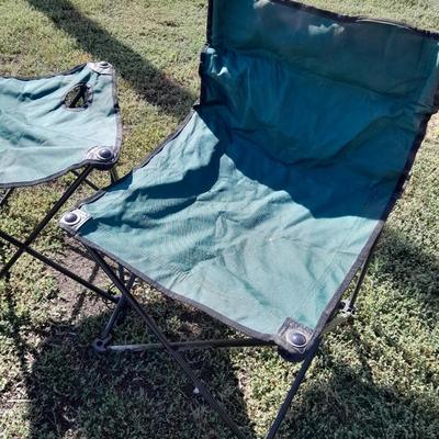 Two folding camp chairs and a folding table with drink holders