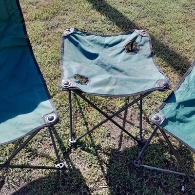 Two folding camp chairs and a folding table with drink holders