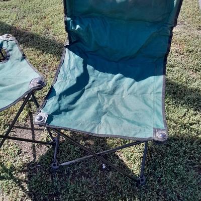 Two folding camp chairs and a folding table with drink holders