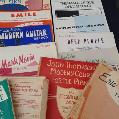 Adjustable music stand with Sheet music and music books for different instruments