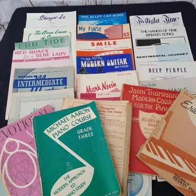 Adjustable music stand with Sheet music and music books for different instruments