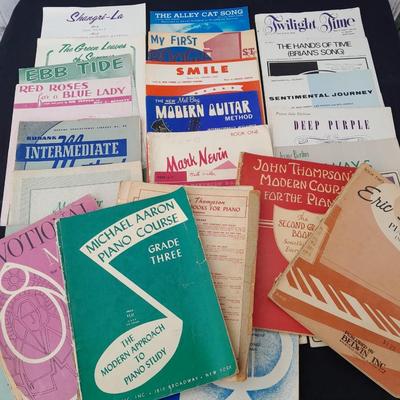 Adjustable music stand with Sheet music and music books for different instruments