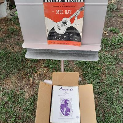 Adjustable music stand with Sheet music and music books for different instruments