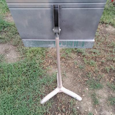 Adjustable music stand with Sheet music and music books for different instruments