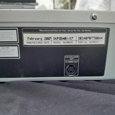 Philips DVD /VHS player with an assortment of DVDS