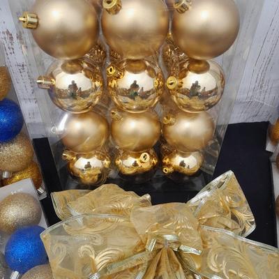 Gold glass Christmas ornaments with blue & gold glitter ornaments and a nice big bow