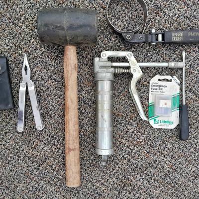Assortment of hand tools - rubber mallet - grease gun - oil filter wrench and more