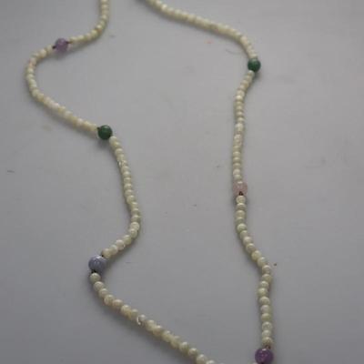White beaded neckalce with pink, green, blue and purple Stone