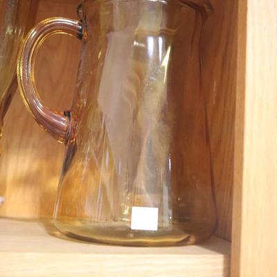 Amber colored water pitcher and vase