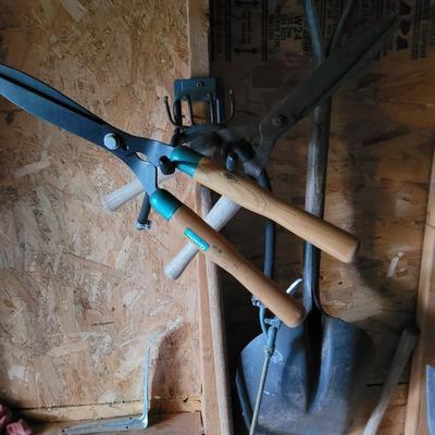 Scoop shovel, 2 limb shears, tined hoe and brass sprayer nozzle