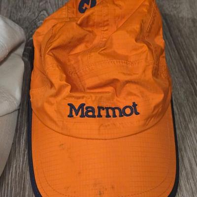 (2) Hats - One Light Tan Cotton Hat and One Orange Marmot Nylon Hat
