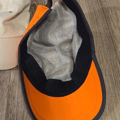 (2) Hats - One Light Tan Cotton Hat and One Orange Marmot Nylon Hat