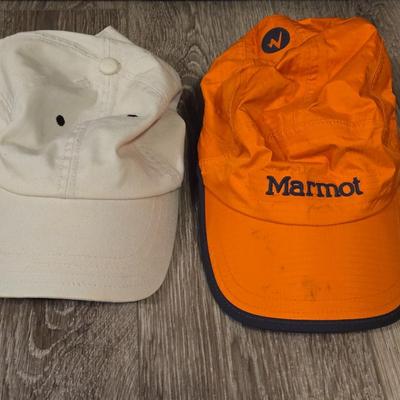 (2) Hats - One Light Tan Cotton Hat and One Orange Marmot Nylon Hat