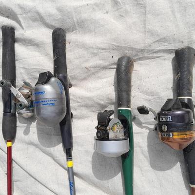 Four fishing poles with reels