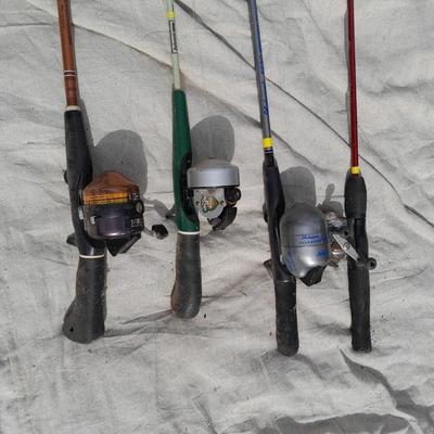 Four fishing poles with reels