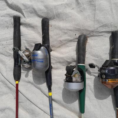 Four fishing poles with reels