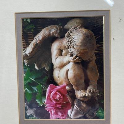 Print of baby angel statue, weeping, framed