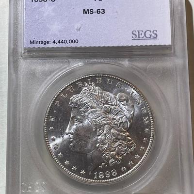 SEGS CERTIFIED 1898-O MS63 PROOF LIKE MORGAN SILVER DOLLAR AS PICTURED. SCARCE "O" FULL STRIKE COIN.