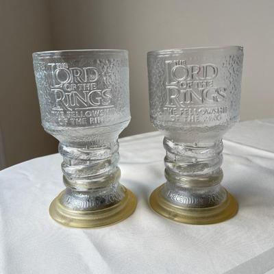 3 Clear Glass Flintstones Mugs and Two Lord of the Rings Goblets