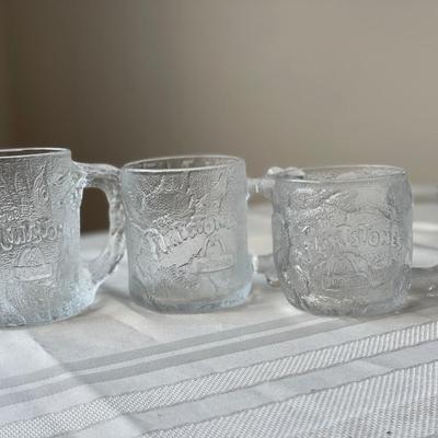 3 Clear Glass Flintstones Mugs and Two Lord of the Rings Goblets