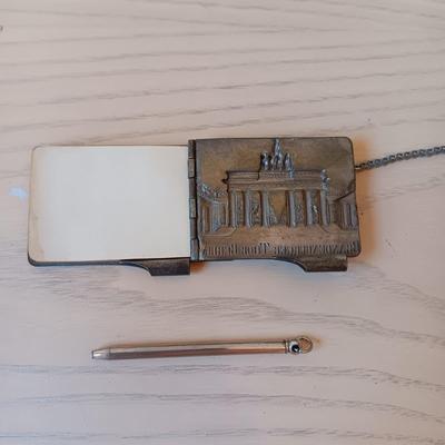 ANTIQUE GERMAN EMBOSSED METAL NOTEPAD WITH PEN AND SMALL PLASTIC POWDER COMPACT