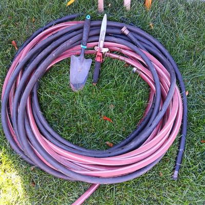 YARD TOOLS AND A GARDEN HOSE