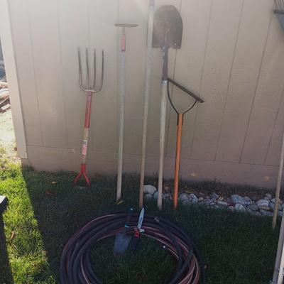 YARD TOOLS AND A GARDEN HOSE