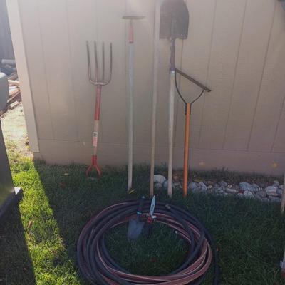 YARD TOOLS AND A GARDEN HOSE