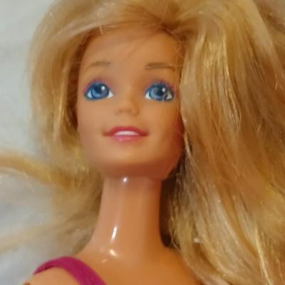 Four 1960's barbie dolls with clothes