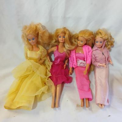 Four 1960's barbie dolls with clothes