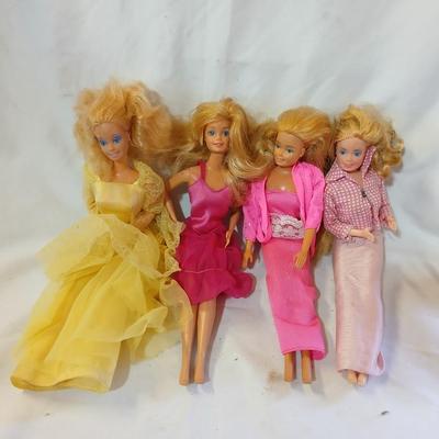Four 1960's barbie dolls with clothes
