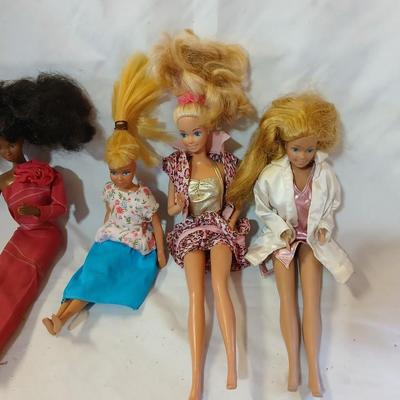 Four 1960's barbie dolls with clothes
