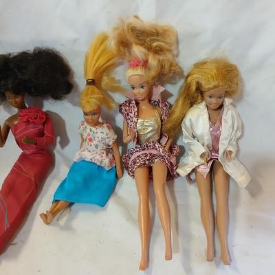 Four 1960's barbie dolls with clothes