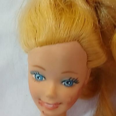 Four 1960's barbie dolls with clothes