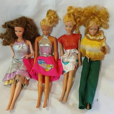Four 1960's barbie dolls with clothes