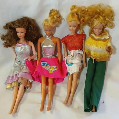Four 1960's barbie dolls with clothes