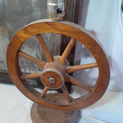 Antique picture frame with wagon wheel lamp